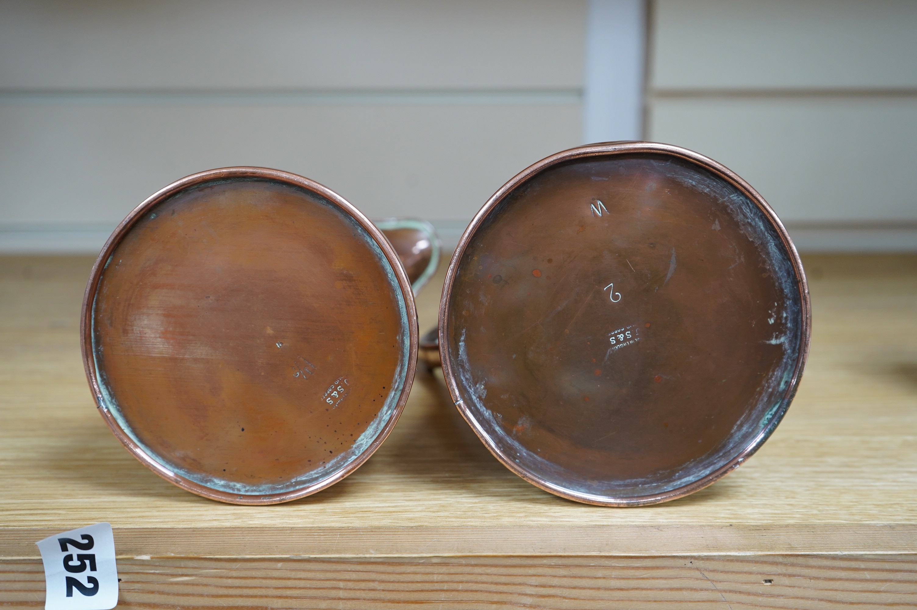 Two Joseph Sankey Art Nouveau embossed copper jugs, tallest 23cm. Condition- fair to good